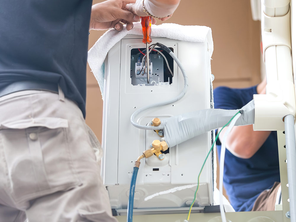 Technicians installing a new mini-split system.